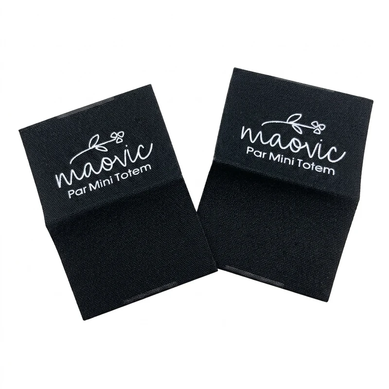 Black folded fabric labels with white lettering.