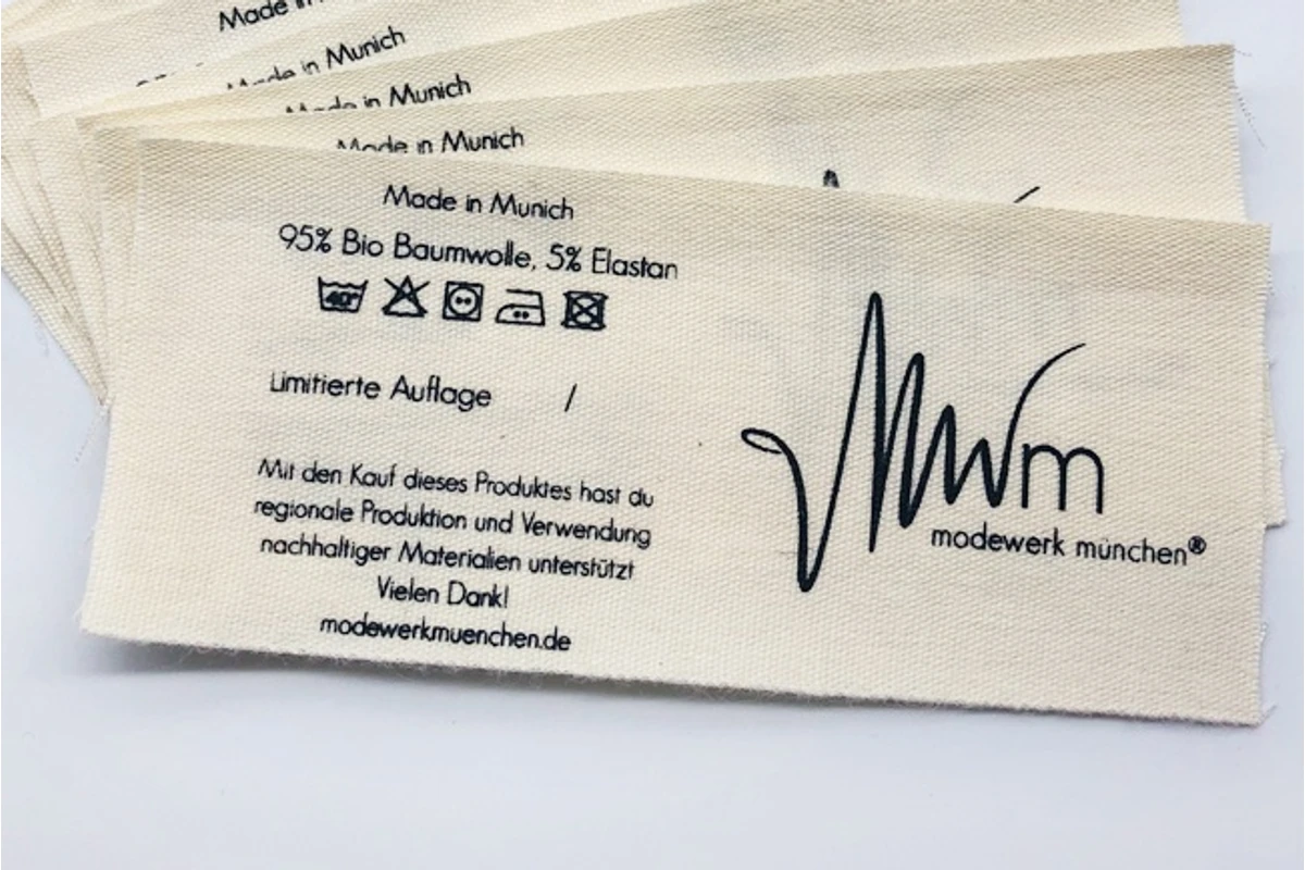 Close-up of a printed garment care label in a fan of fabric samples.