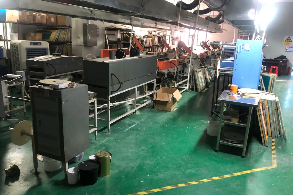 Production equipment and work tables in a label workshop.