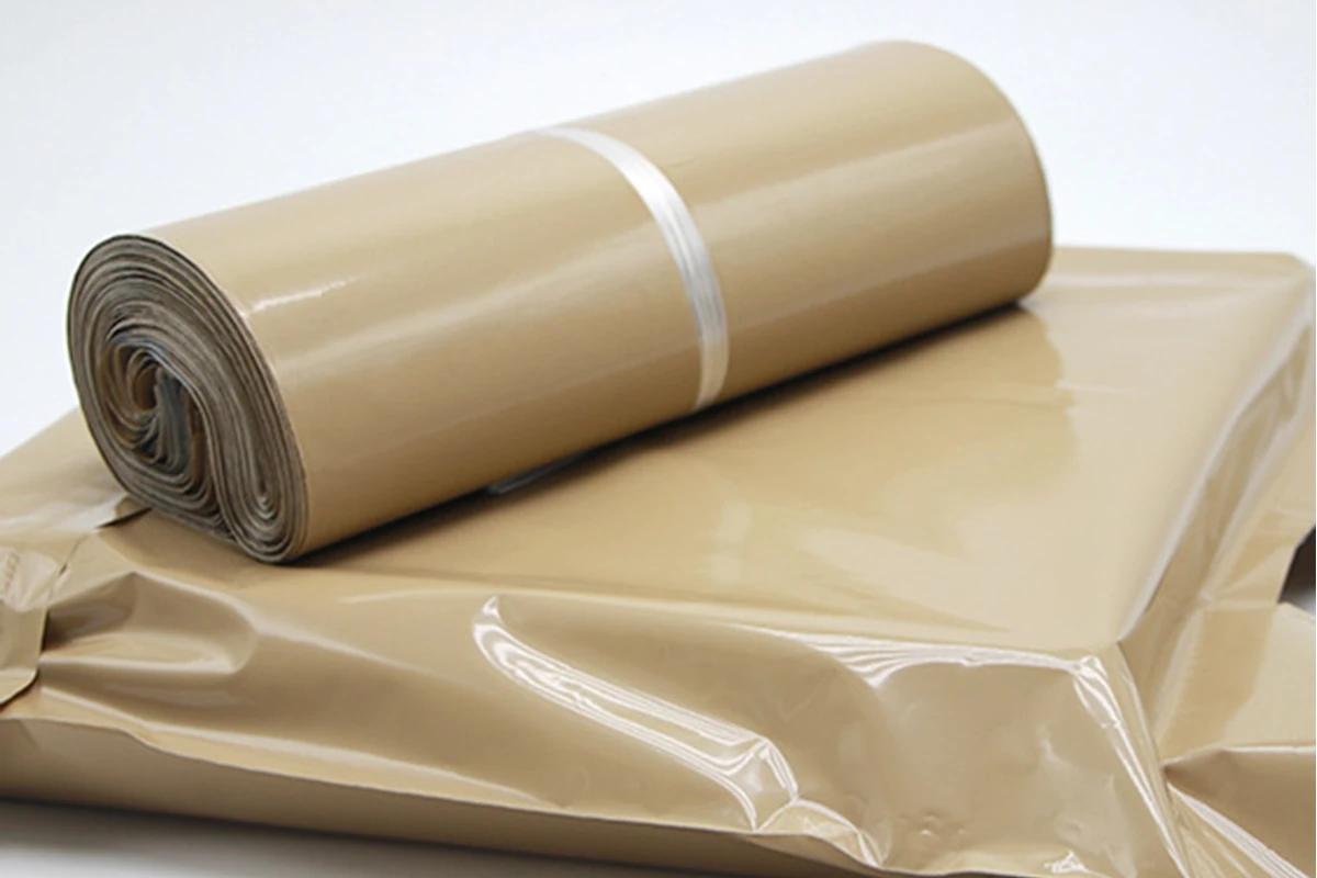 A close-up of a kraft-colored packing roll and stacked sheets.