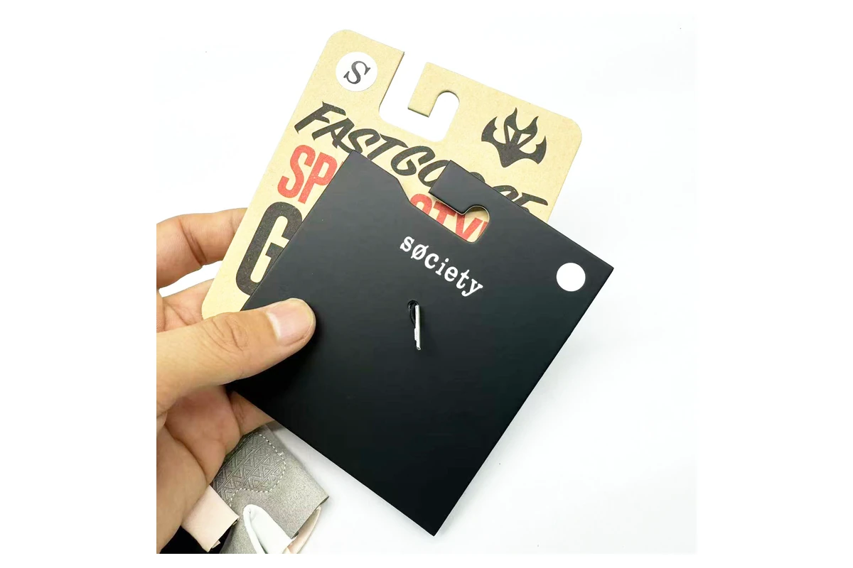 A hand holding finished printed hanging cards.