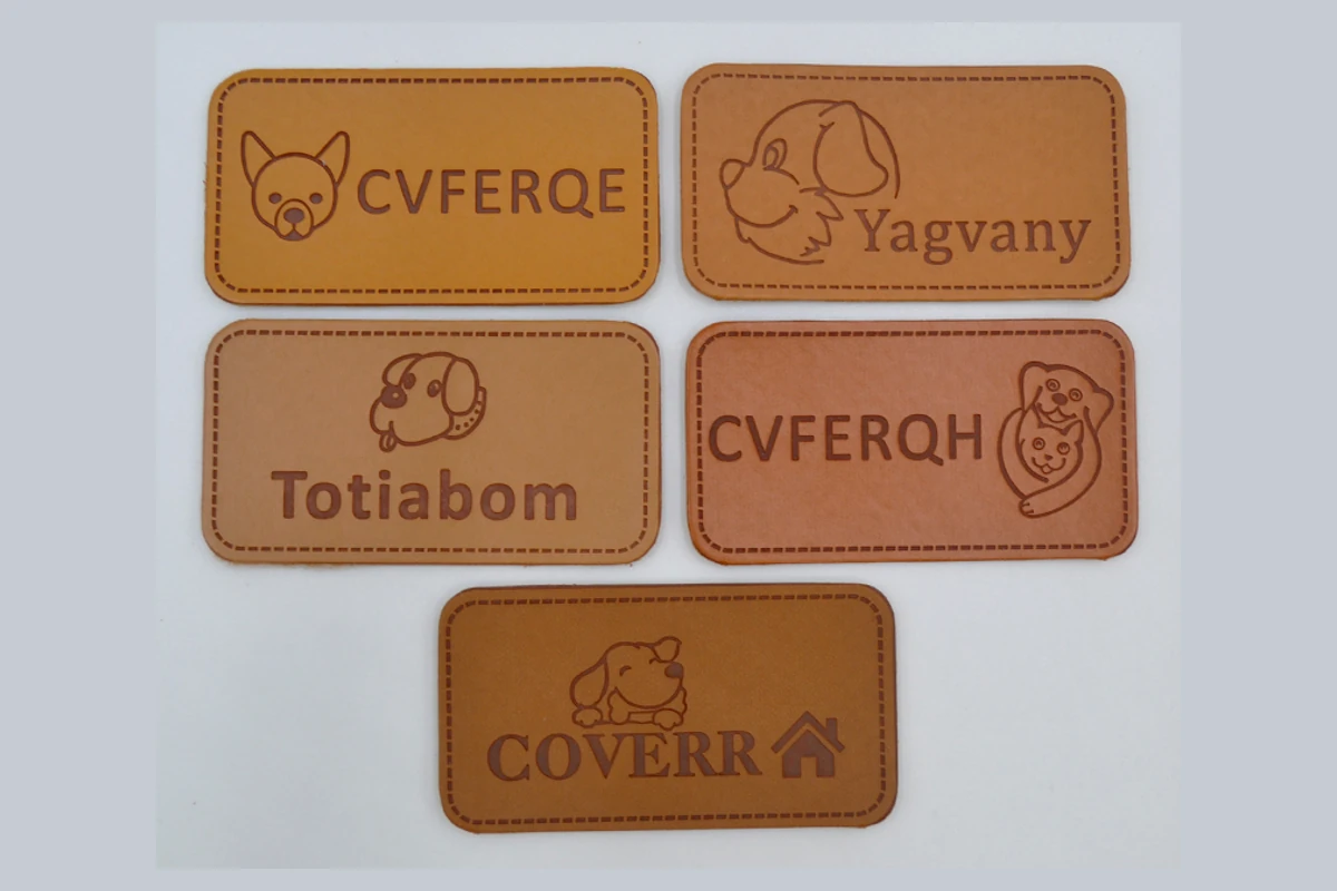 Rectangular leather-label samples with names and decorative designs.